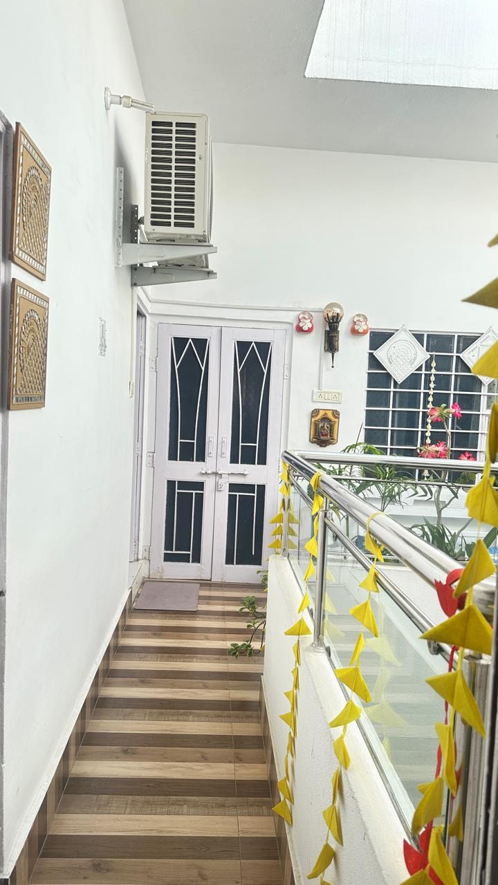 Passage to rooms with yellow bunting and folk art